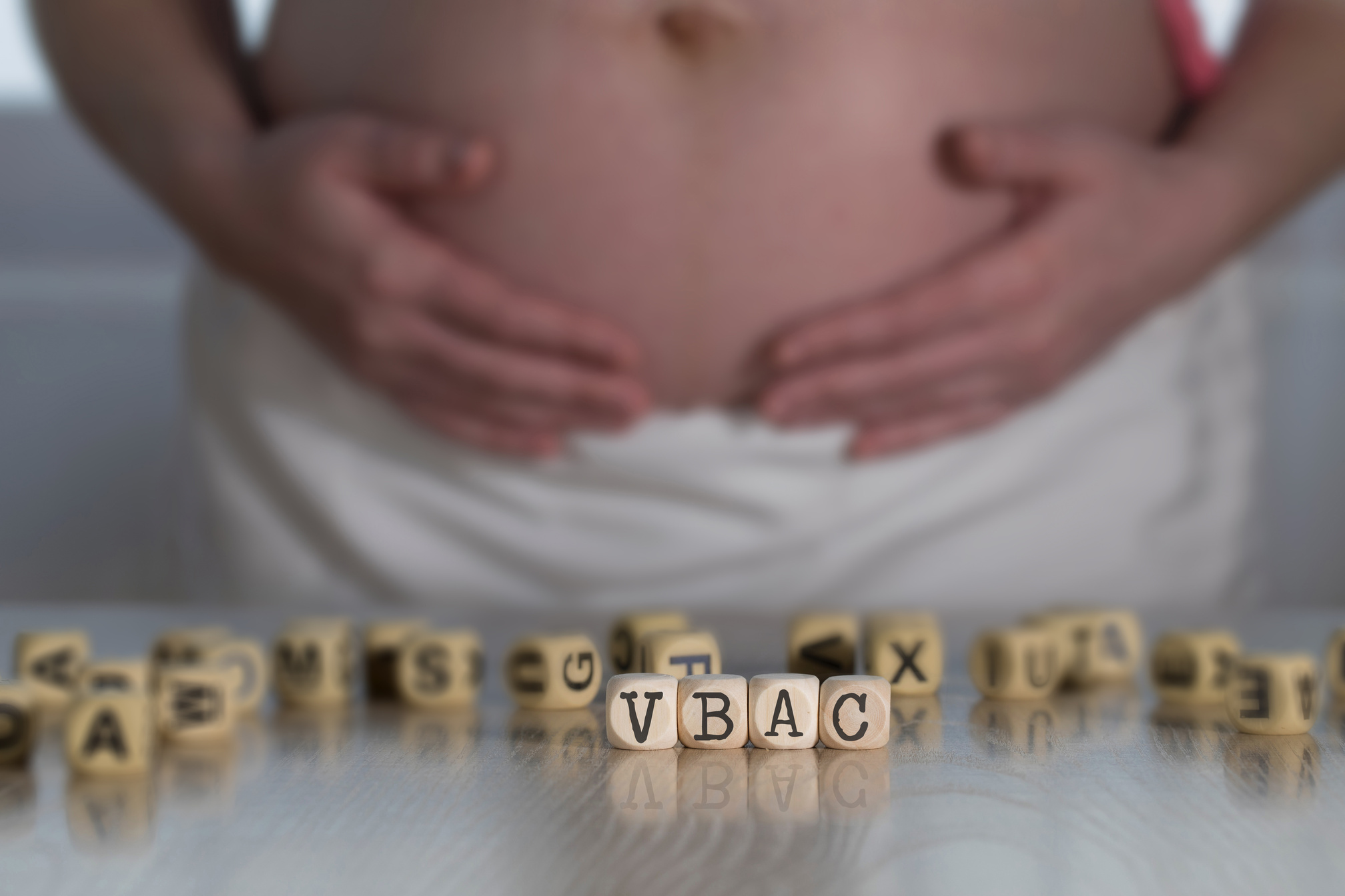 Abbreviation VBAC composed of wooden letters for Vaginal Birth after Caesarean.